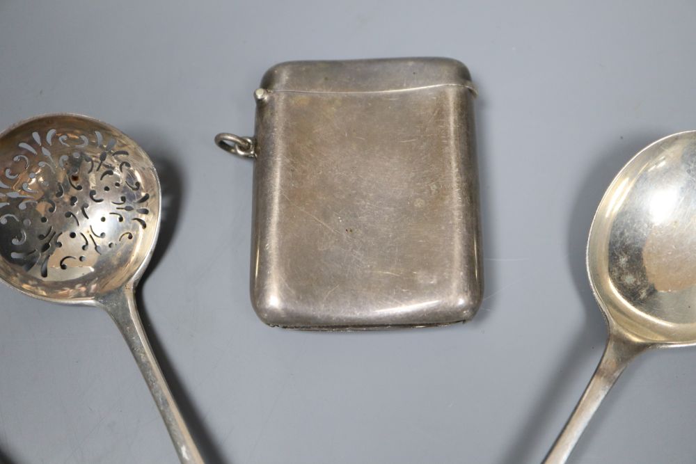 A George V silver vesta case and thirteen pieces of cutlery including eight silver.